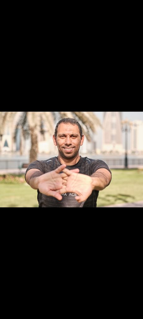 Personal trainer Mohammed coaching a client outdoors in Sharjah