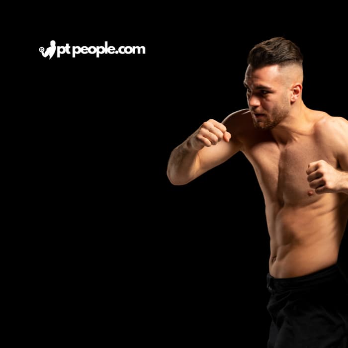 MMA combat instructor coaching a group in a self-defense class