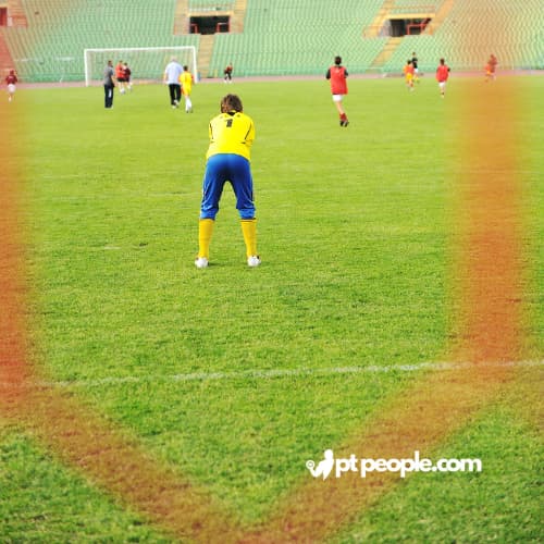 Young children learning dribbling skills in a local football training program.