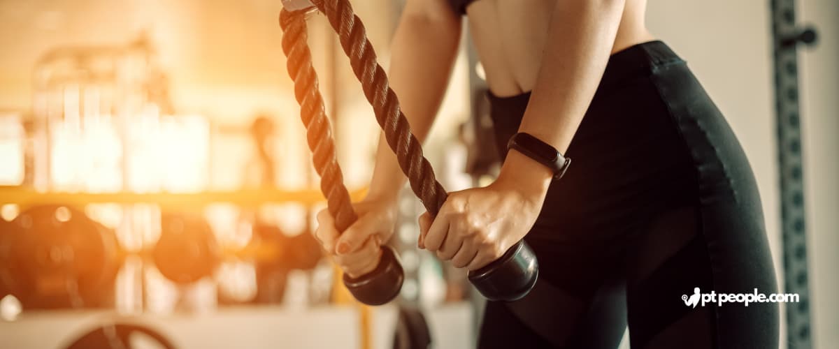 Group fitness class in new york focused on body toning exercises using resistance bands.
