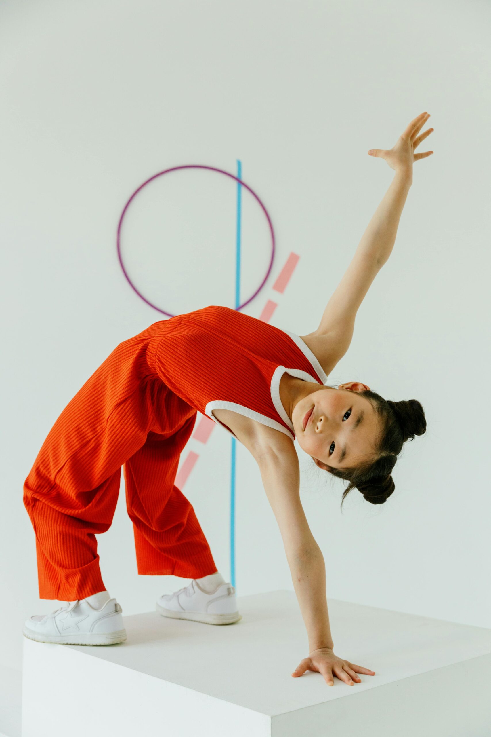 Young girl practicing cartwheels in a kids' gymnastics class
