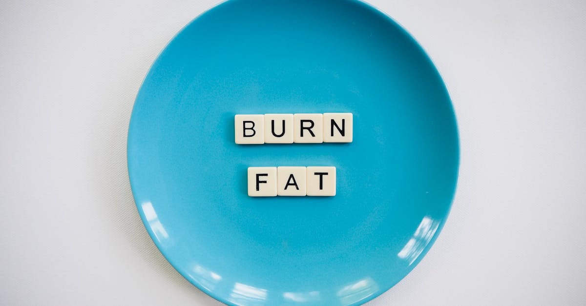 A conceptual image featuring the words 'Burn Fat' on a blue plate, symbolizing weight loss.