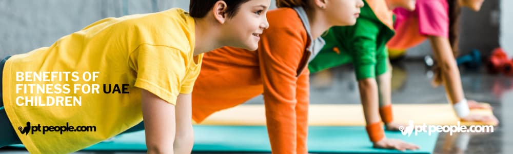 Diverse group of Dubai kids practice yoga poses in a playful and encouraging class, promoting flexibility, mindfulness, and body awareness from a young age.