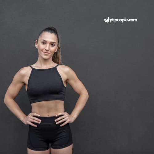 Confident woman in Dubai celebrating fitness milestones with her female personal trainer. (This describes the positive outcome, location, and keyword "Female Personal Trainers Dubai", focusing on achieving goals with a female trainer).
