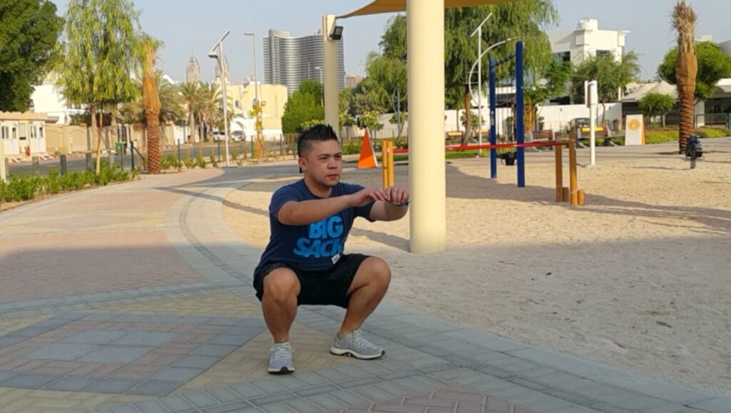 Dubai personal trainer Chester Tan leading strength training and rehabilitation workout session for clients over 40 in Dubai gym