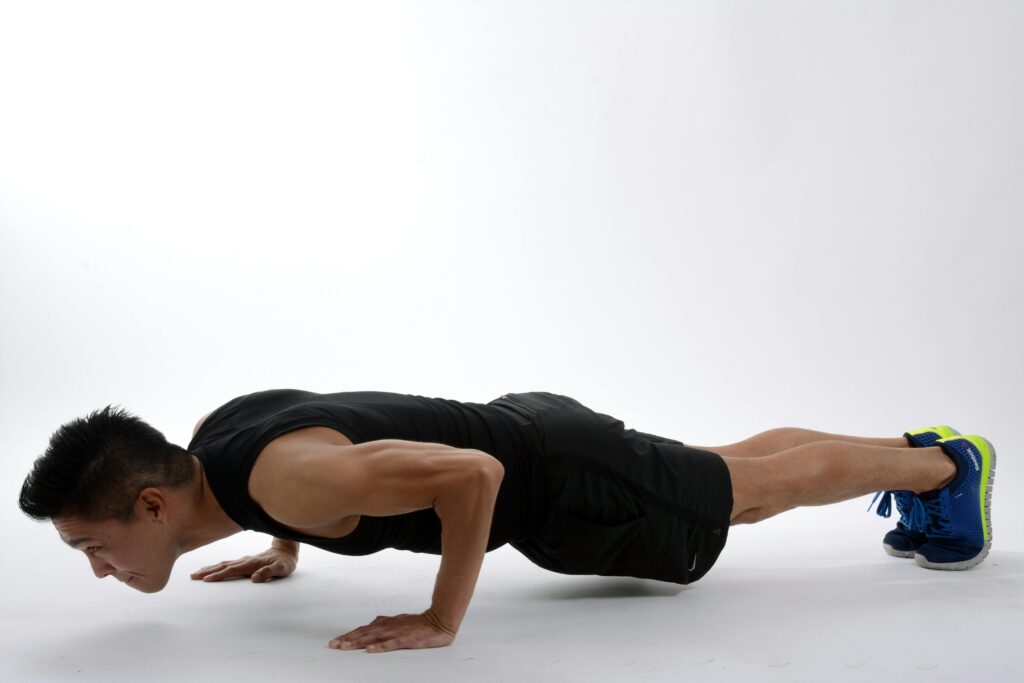 Male and female personal trainer coaching clients in gym